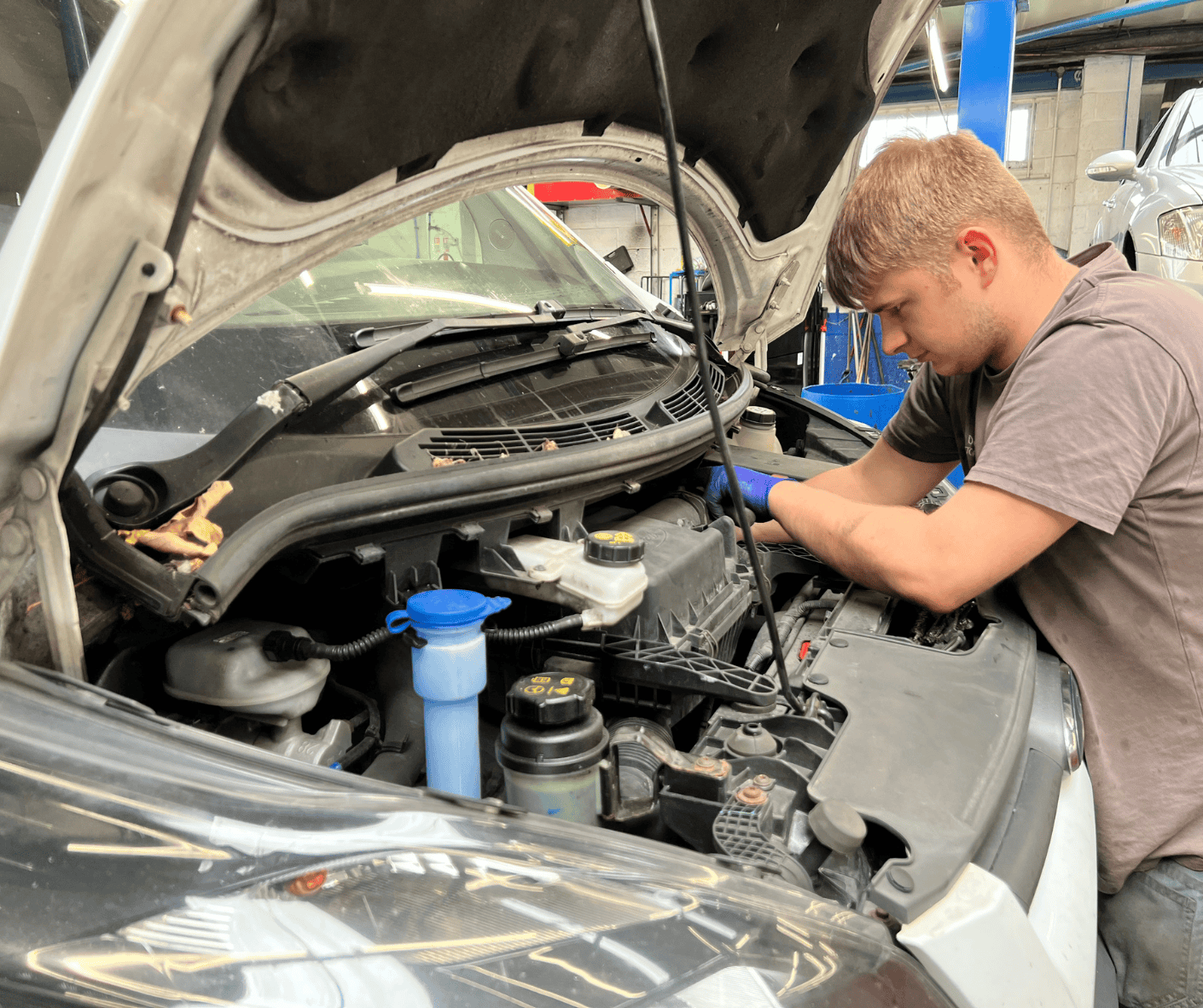 Vehicle technician carrying out a full car service