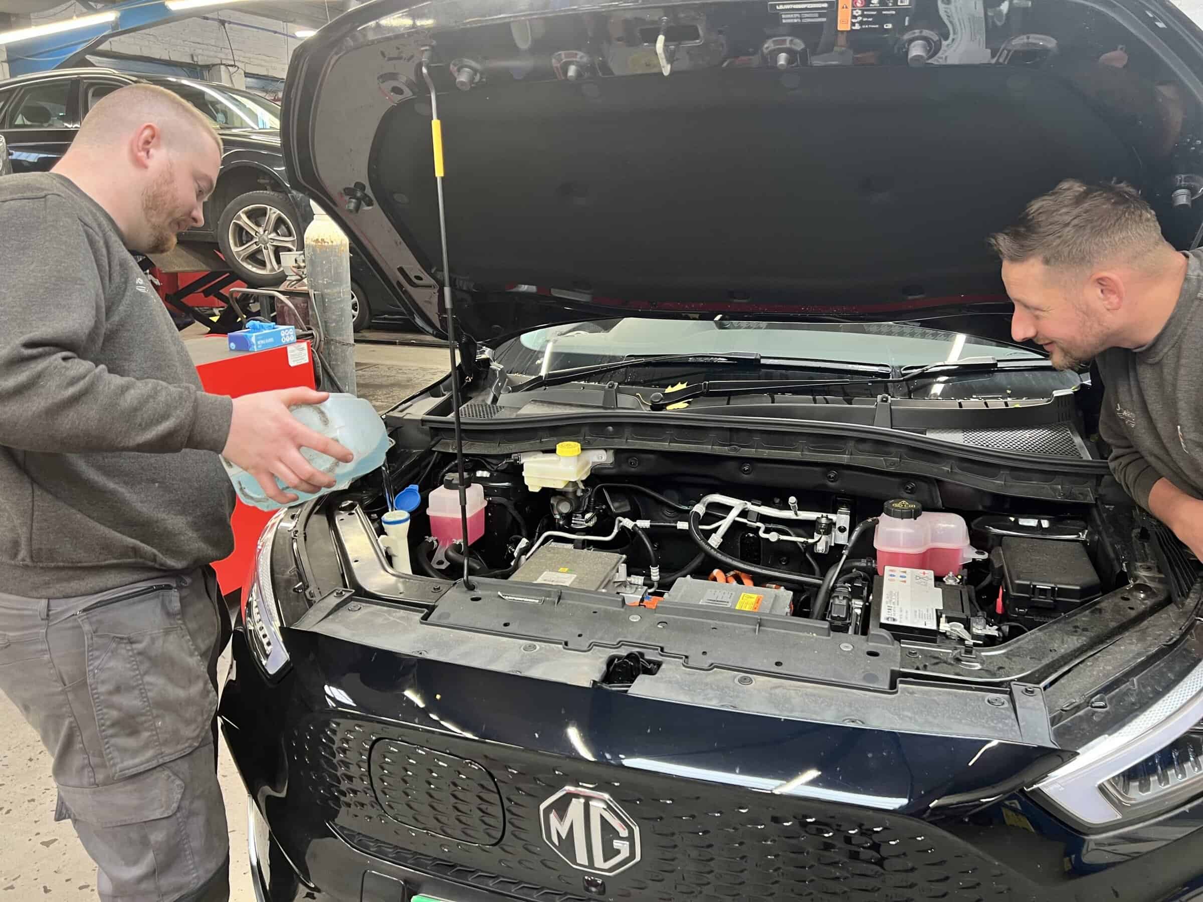 Mechanics checking car